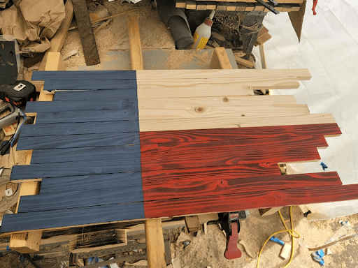 Wooden American flag being cut, assembled and stained in workshop